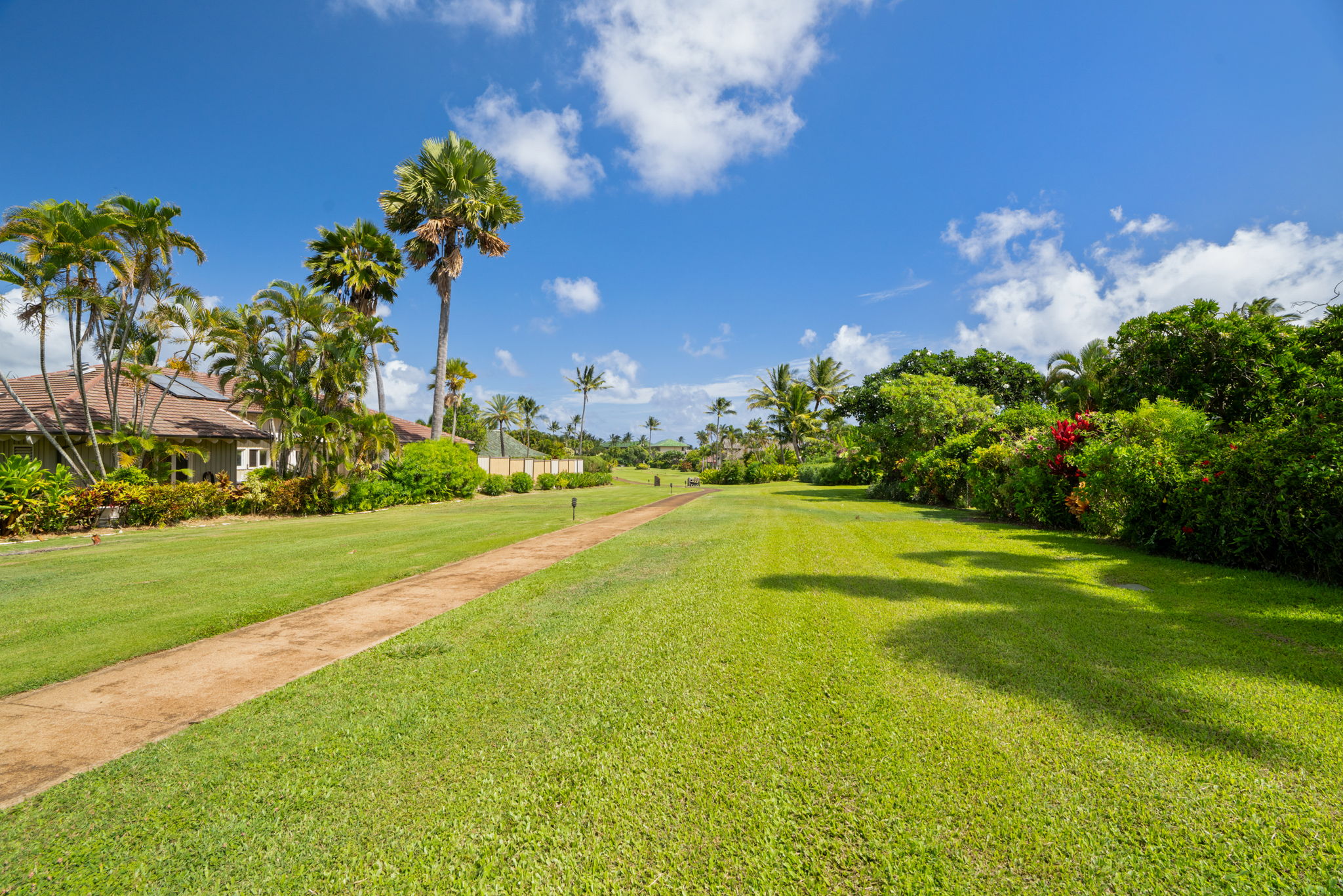 Greenbelt path: A landscaped path leading toward one of Poipu's beaches